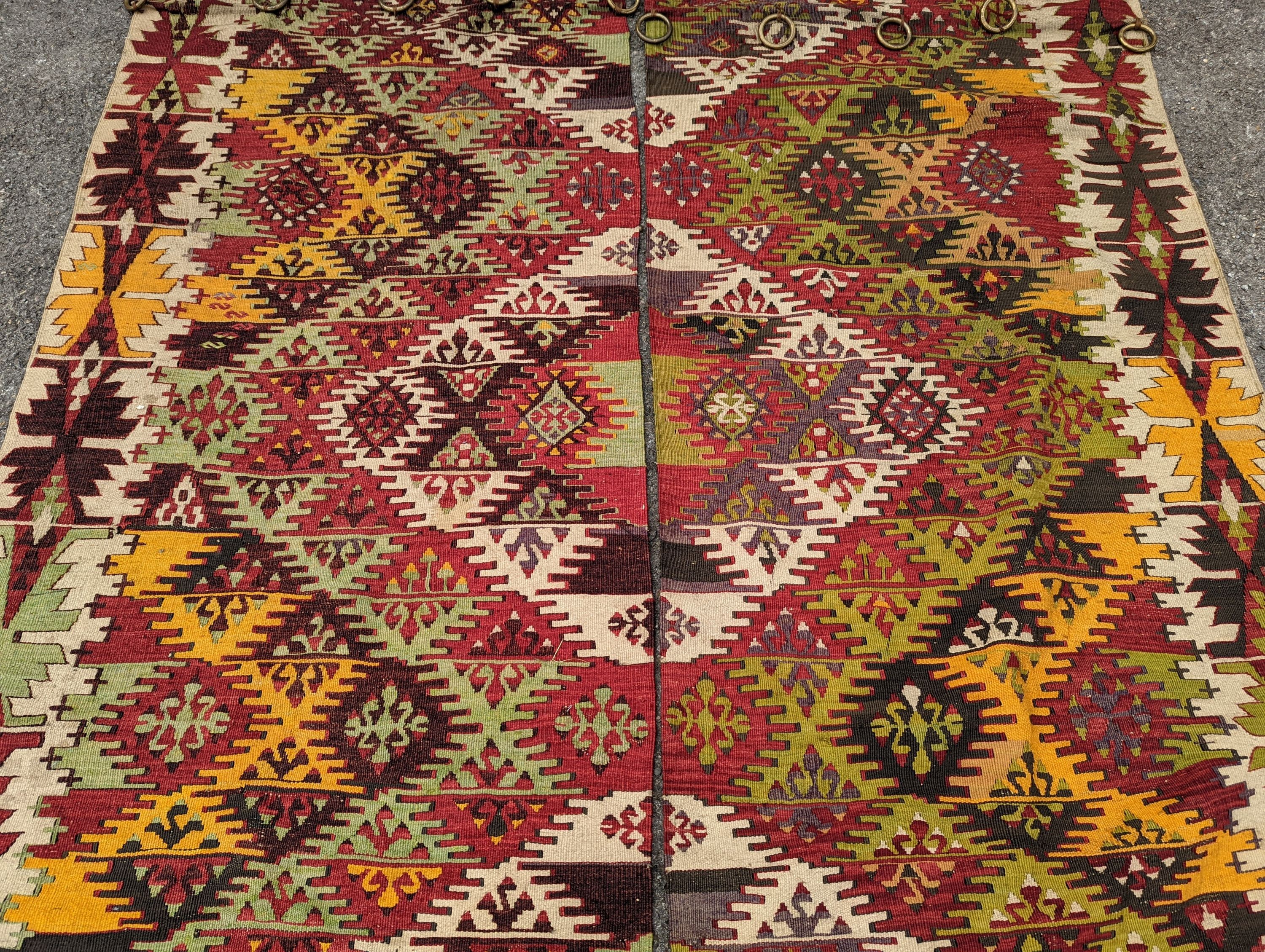 A Kelim polychrome flatweave carpet, cut centrally to create a pair of runners, each 410 x 85cm